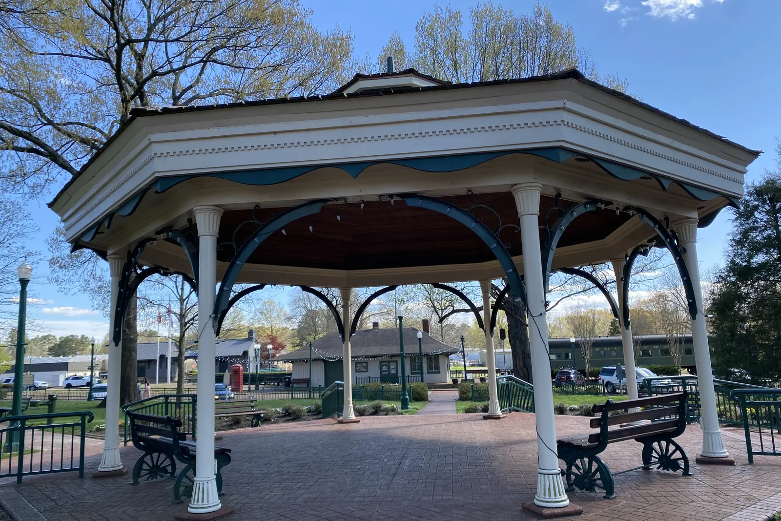 The white gazebo at the heart of Town Square Park in Collierville, with the depot and shops beyond.