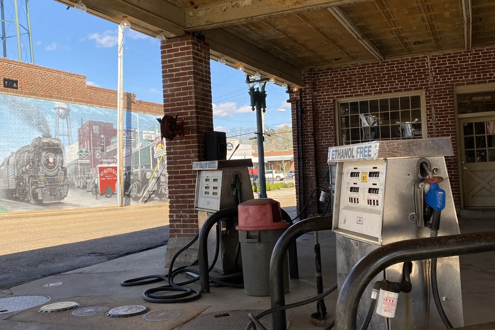 Vintage gas pumps under the canopy of the old service station on the Collierville Town Square.