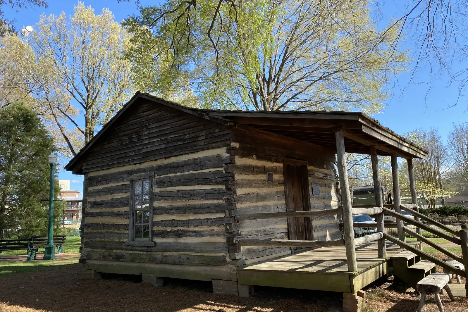 The historic log cabin in Town Square Park on the Collierville Town Square.