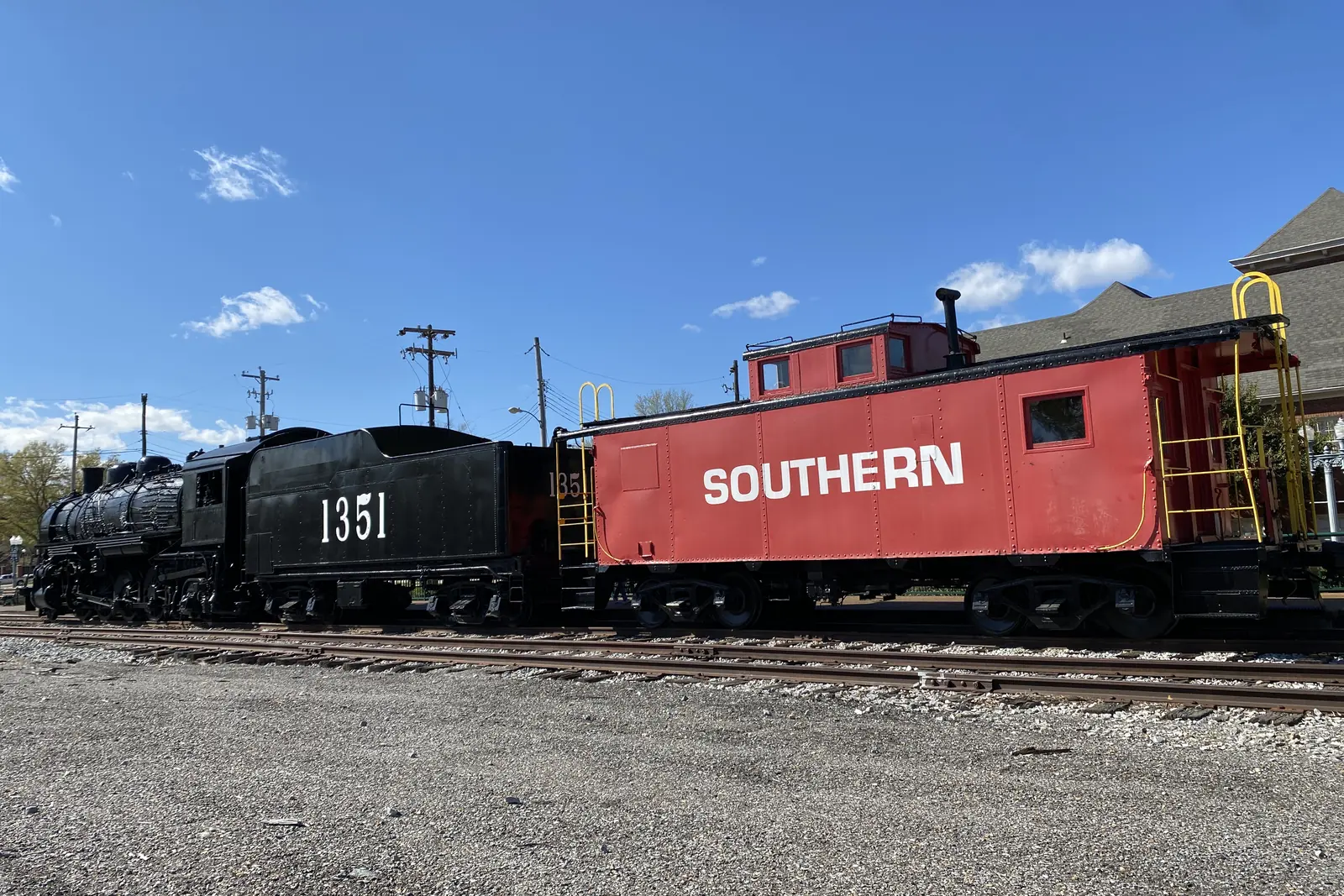 Steam locomotive No. 1351 and a red Southern caboose beside the depot on the Collierville Town Square, the center of Christmas in Collierville.