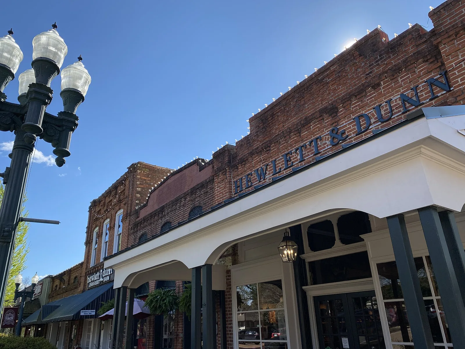 Brick storefronts and iron lampposts on the Collierville Town Square.