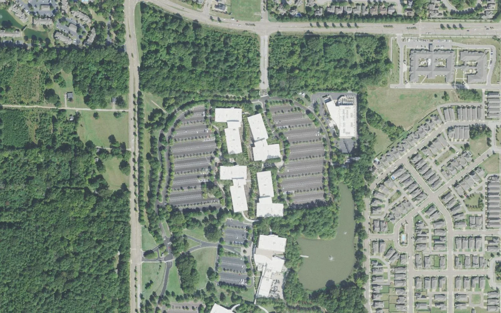 Bailey Station in Collierville from the air: office buildings and parking around a pond, with rows of homes to the east