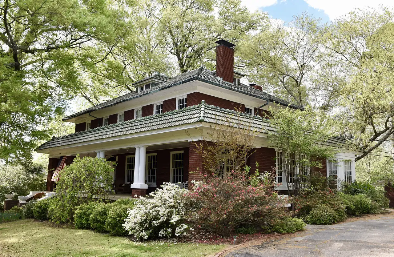The John B. McFerrin House, a two-story brick home with a wraparound porch, at 156 W. Poplar Ave. in Collierville's historic district
