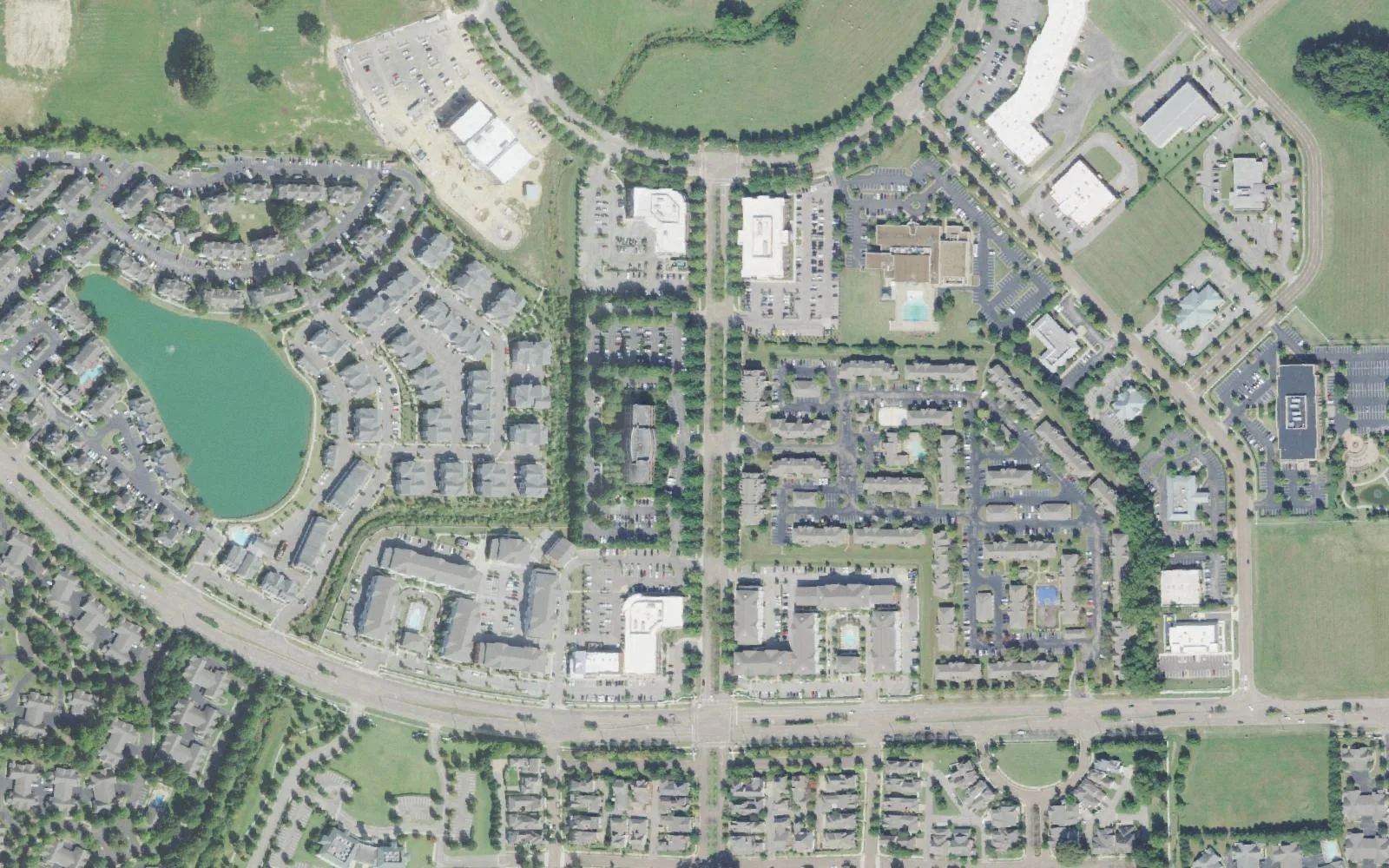 Schilling Farms in Collierville from the air: apartments, offices and homes around a lake and a tree-lined boulevard