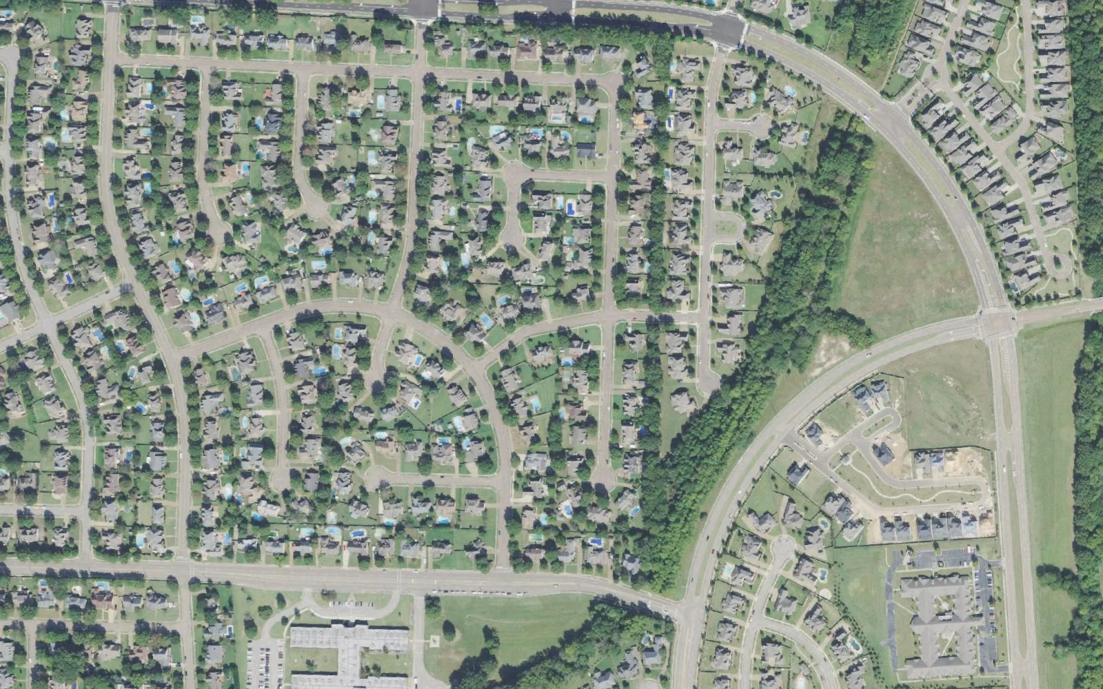 Wolf River Ranch and Wellington Farms in Collierville from the air: streets of homes west of North Byhalia Road, with Wolf River Boulevard curving across at right