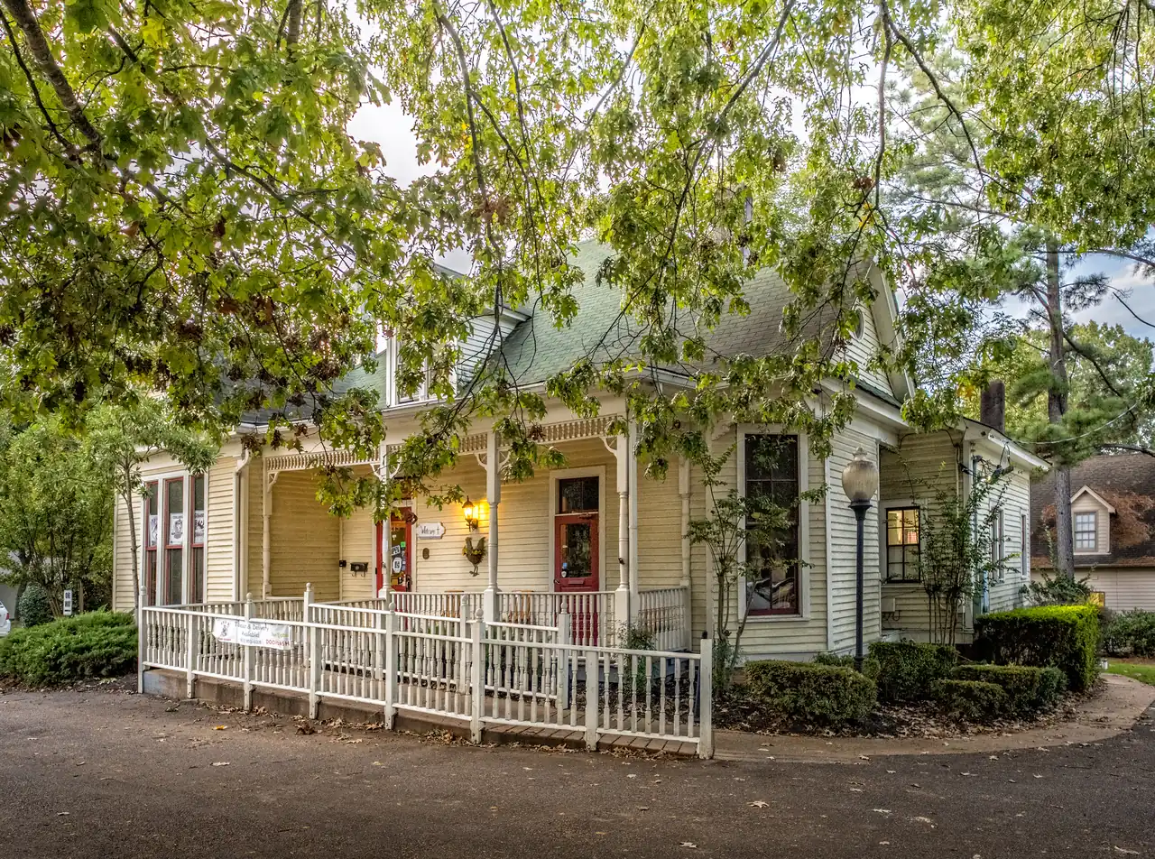 The Joseph A. Campbell House, a cream-colored frame house with a gingerbread porch, at 215 South St. in Collierville's historic district