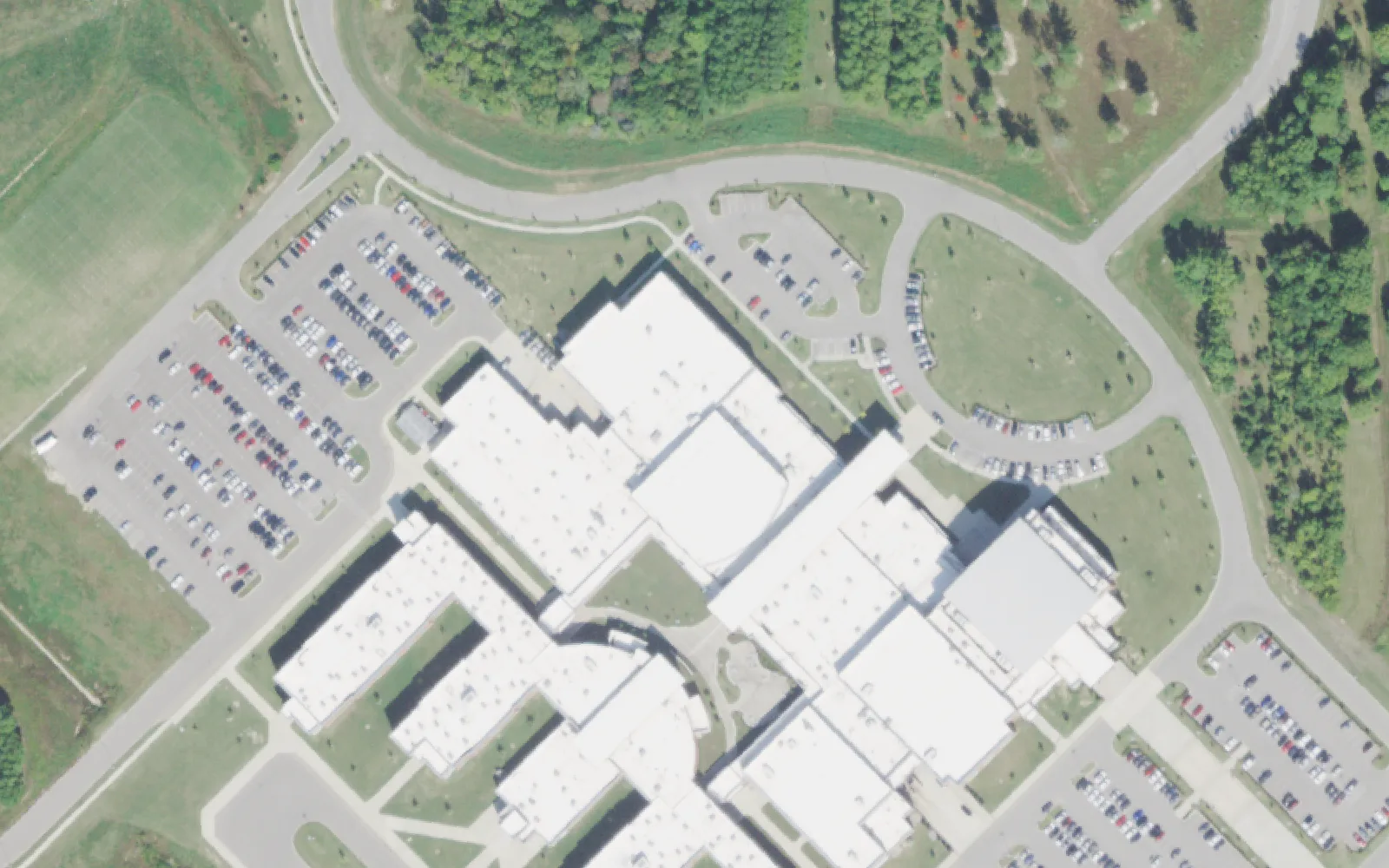 Collierville High School's main building and parking lots off East Shelby Drive in Collierville, seen from the air.