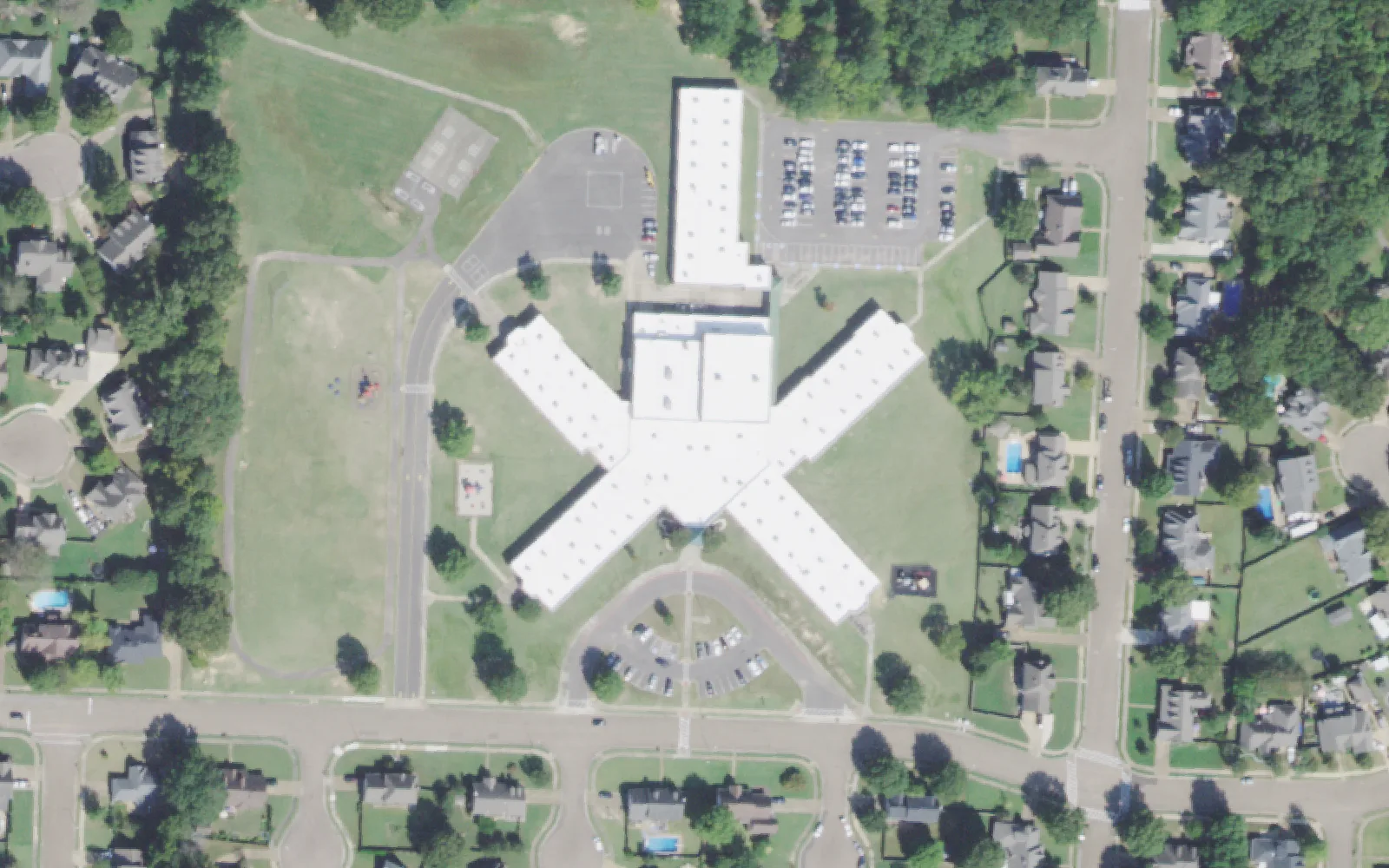 Tara Oaks Elementary School's X-shaped building, parking lots and playing field off East Harpers Ferry Drive in Collierville, seen from the air.